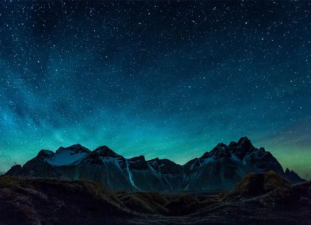 Cordillera nevada bajo un cielo estrellado